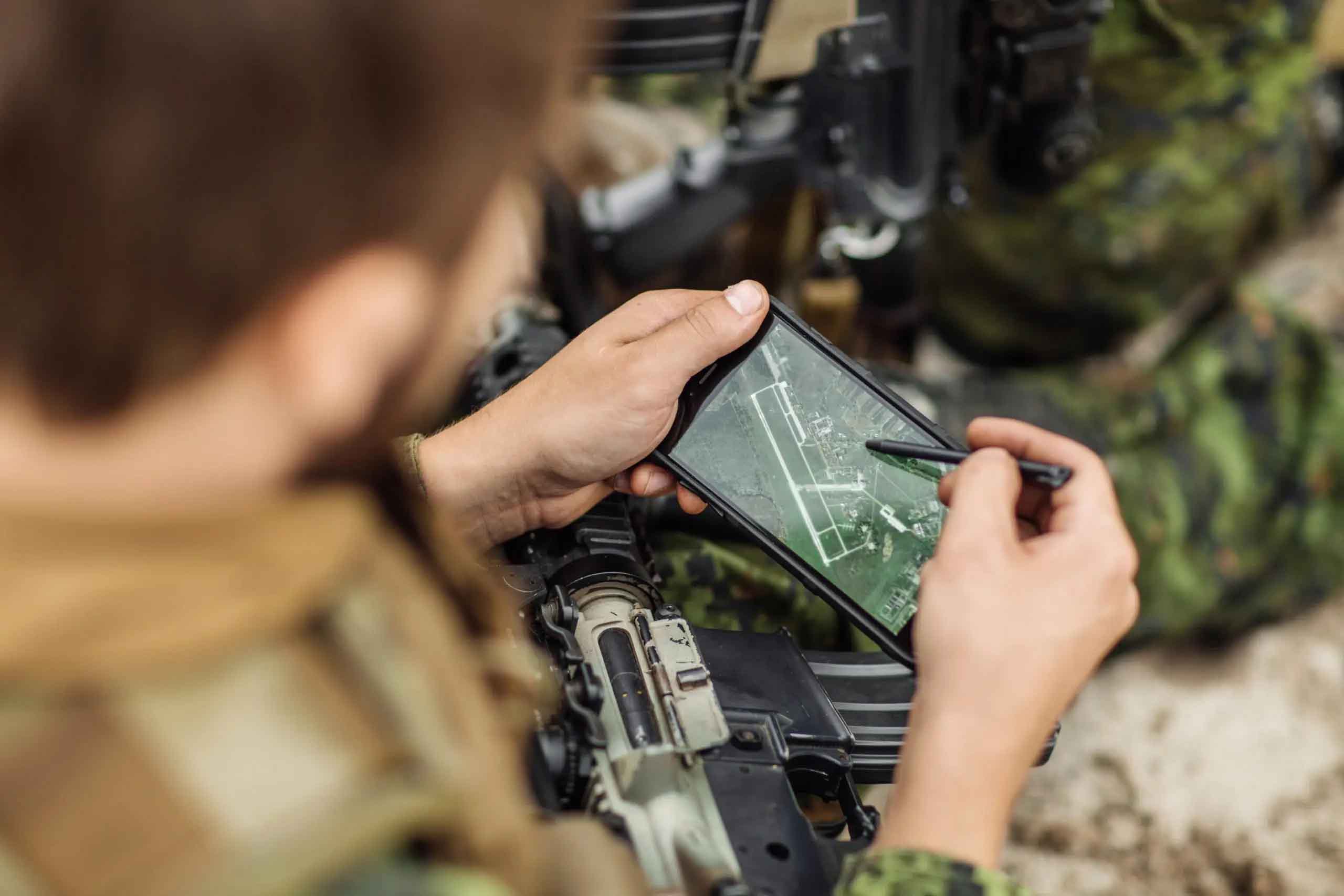 Close view of a soldier using a tablet to visualise an area