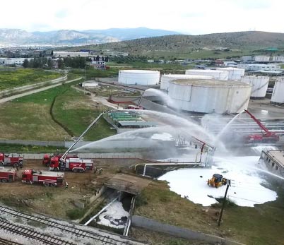 Drone view showing firefighters operating in a refinery in Greece
