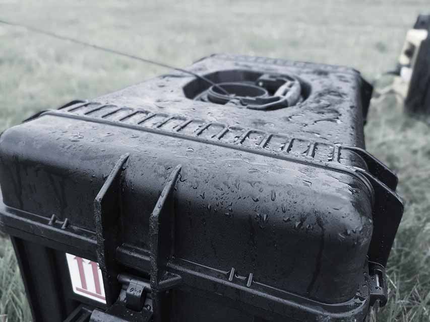 Clos view of the Safe-T 1 Tethered drone station on the ground with drops of rain on it