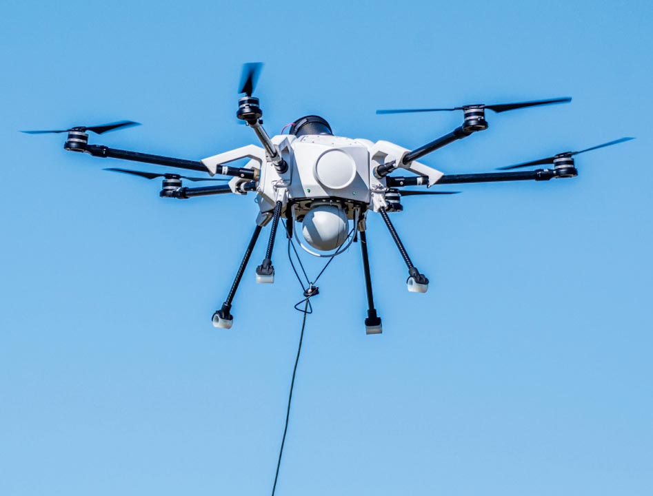 Elistair Orion 1 tethered drone flying in a clear blue sky