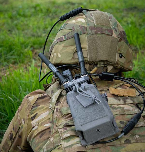 Soldier in uniform with communication equipment on the back
