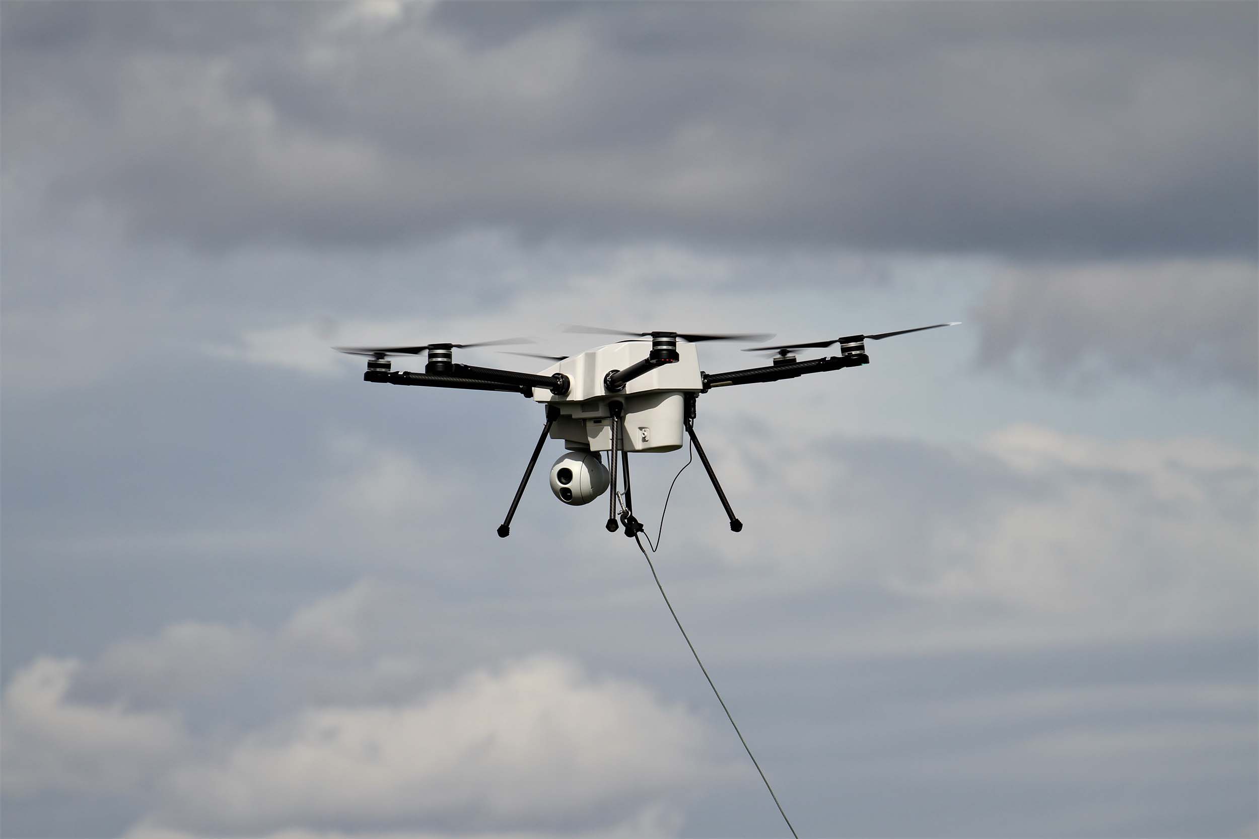 Captive drone in a cloudy sky