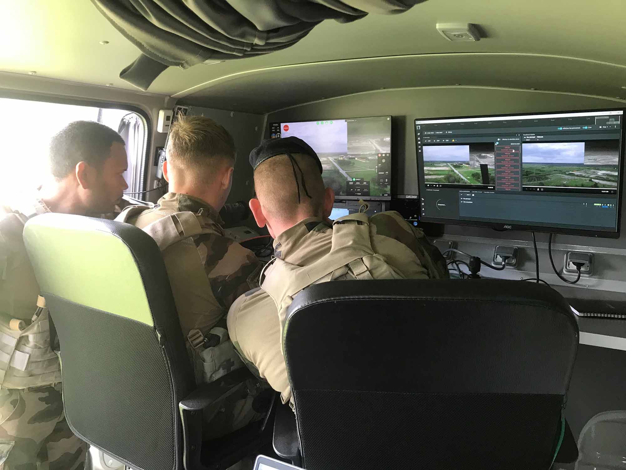 Soldiers watching video feedback from military drone