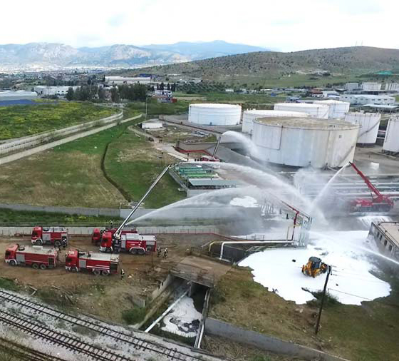Firefighters extinguishing fire at petroleum plant