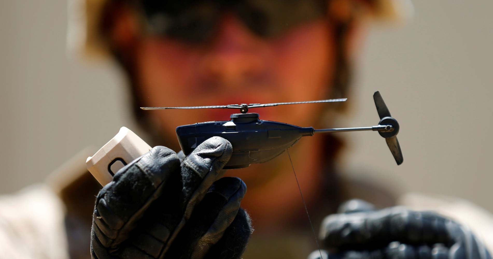 Nano drone held by a gloved hand