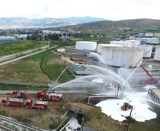 Firefighting operations at an industrial site with drones and fire trucks
